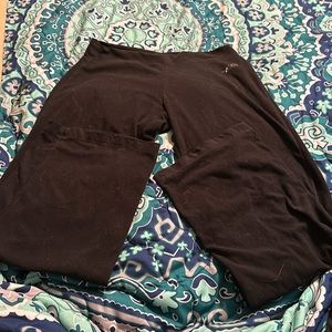 North Face flare leggings. North face is faded. Has a little bleach stain on leg